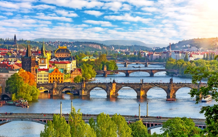 Prague cityscape with bridges over Vltava river at summer sunset, Czech Republic